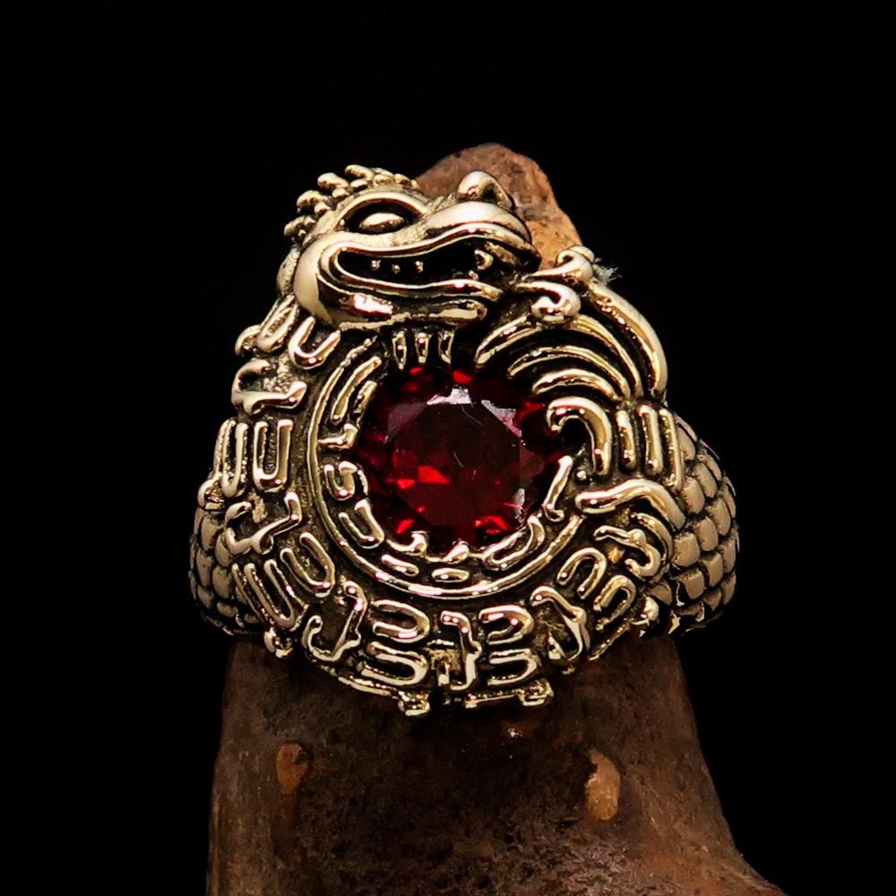Men's Brass Ring featuring an Ancient Maya Inca dragon design with a vibrant red cubic zirconia stone, showcasing intricate details.