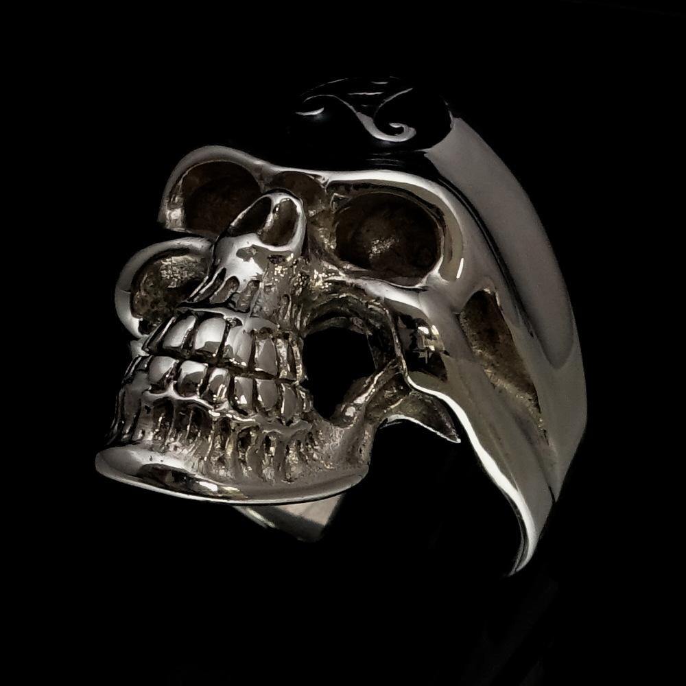 Men's Celtic Triskelia Triad Skull Ring in solid sterling silver with black enamel finish, showcasing intricate design and polished surface.