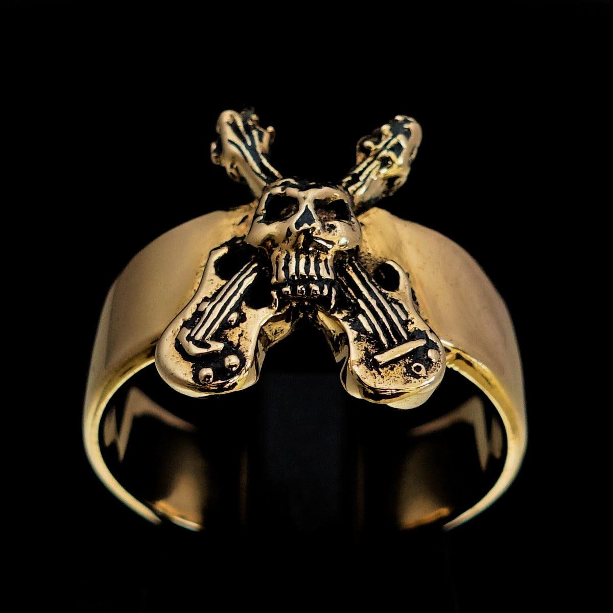 Men's Costume Skull Ring featuring two crossed guitars, crafted from solid brass with an antiqued and polished finish.