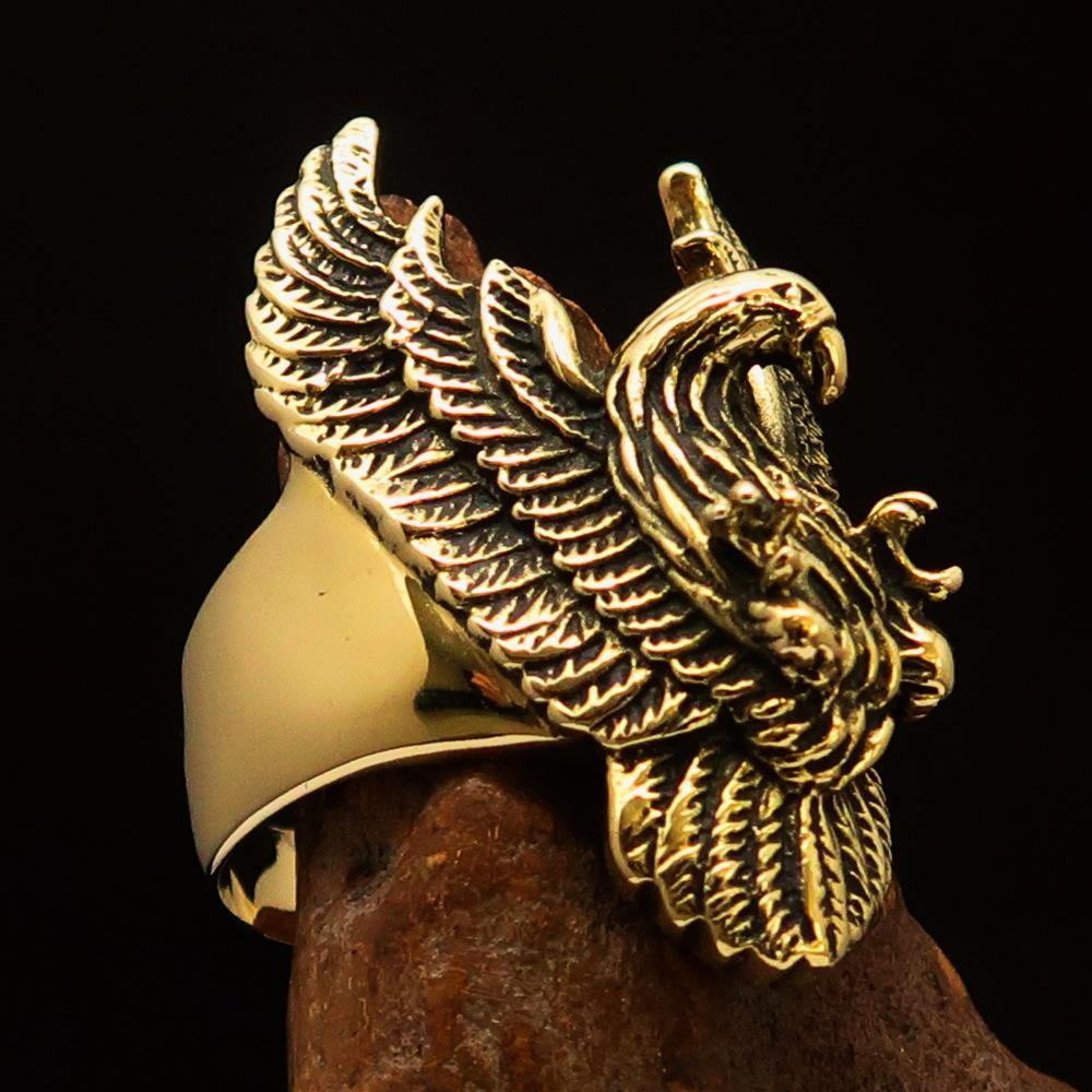 Men's eagle ring made of solid brass with intricately designed spread wings, showcasing a high polish and antiqued finish.