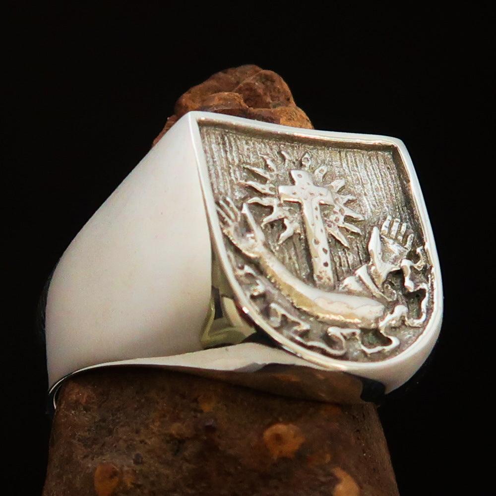 Men's Franciscan Corona Cross Ring in antiqued sterling silver, showcasing intricate cross design and polished finish.