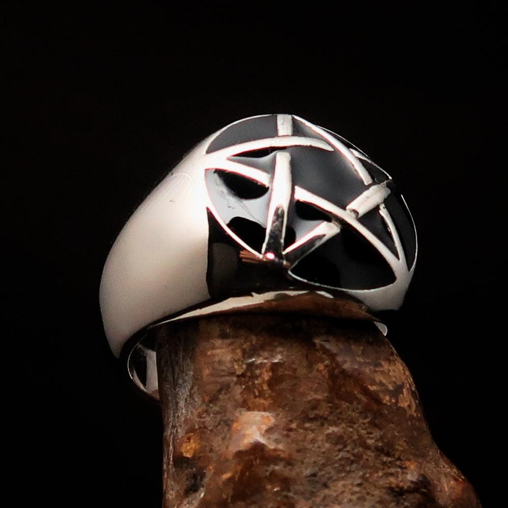 Men's sterling silver pinky ring featuring a domed black pentagram design, polished finish, and solid back.