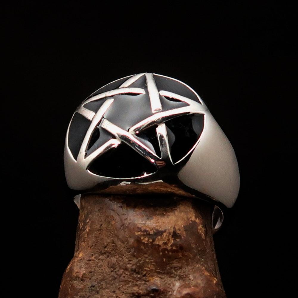 Men's sterling silver pinky ring featuring a domed black pentagram design, polished finish, and solid back.
