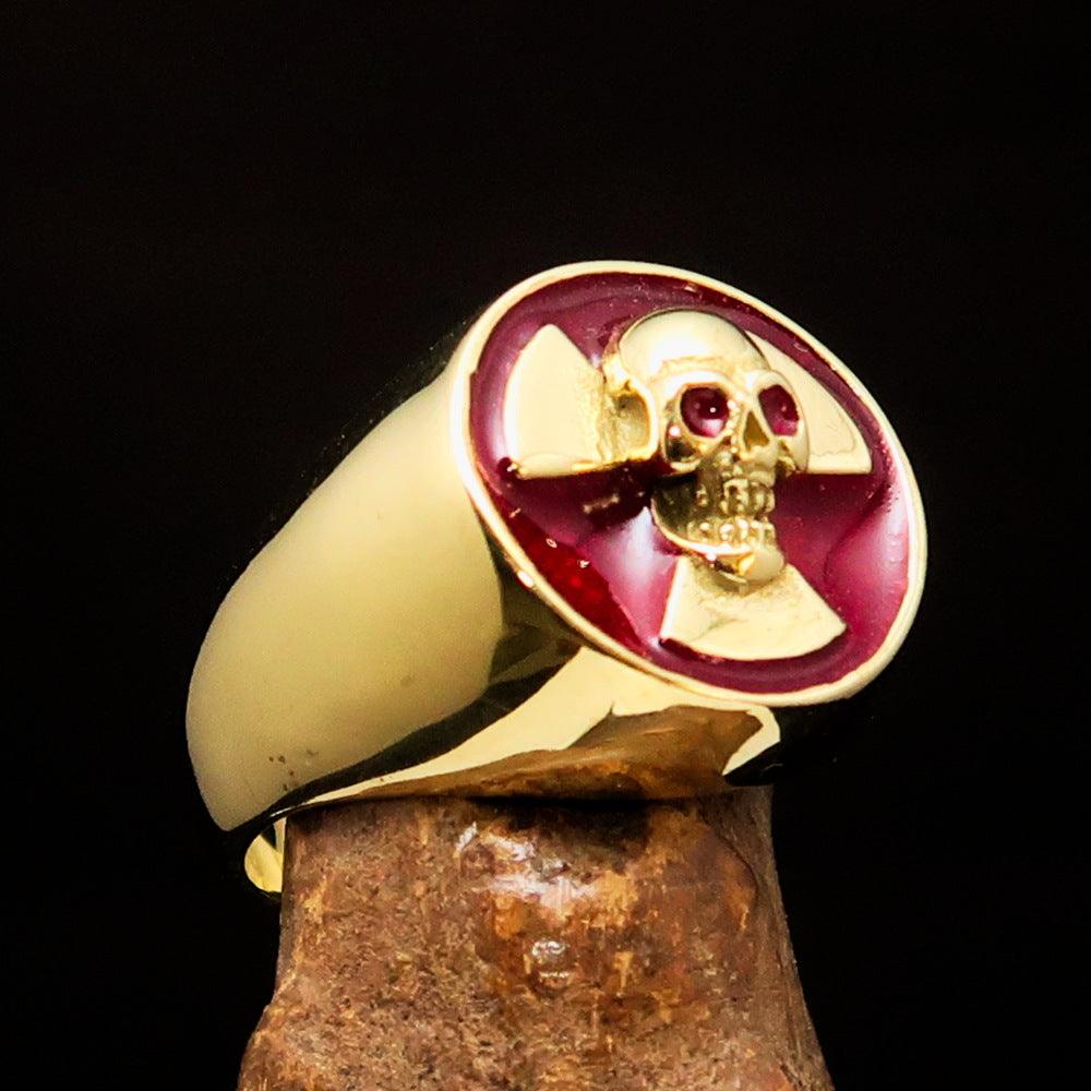 Men's red radioactive skull ring made of solid brass with high polish and red enamel finish, showcasing a unique skull design.