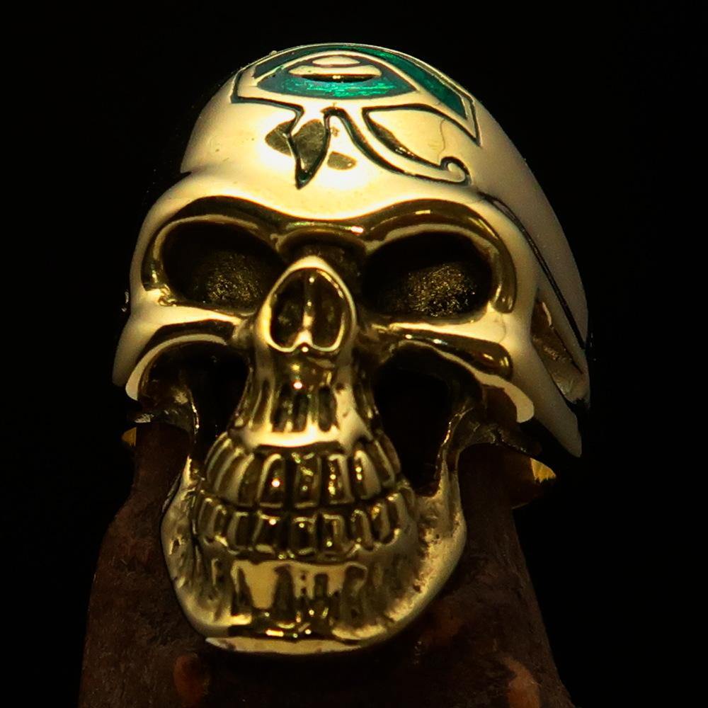 Men's Skull Ring made of solid brass featuring the Eye of Ra with a green enamel finish, showcasing intricate details and a polished surface.