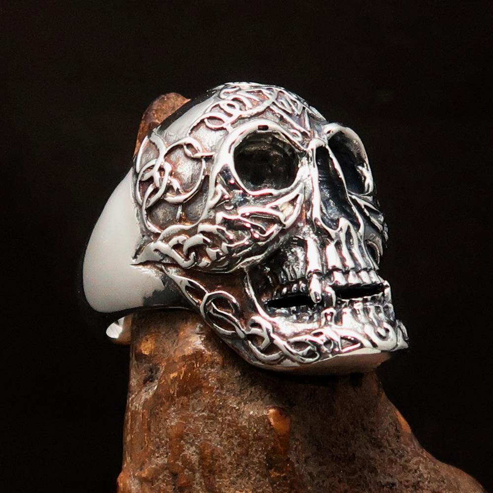 Men's sterling silver Celtic skull ring with intricate design and polished finish, showcasing its unique craftsmanship.