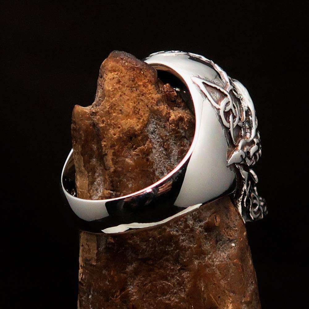 Men's sterling silver Celtic skull ring with intricate design and polished finish, showcasing its unique craftsmanship.