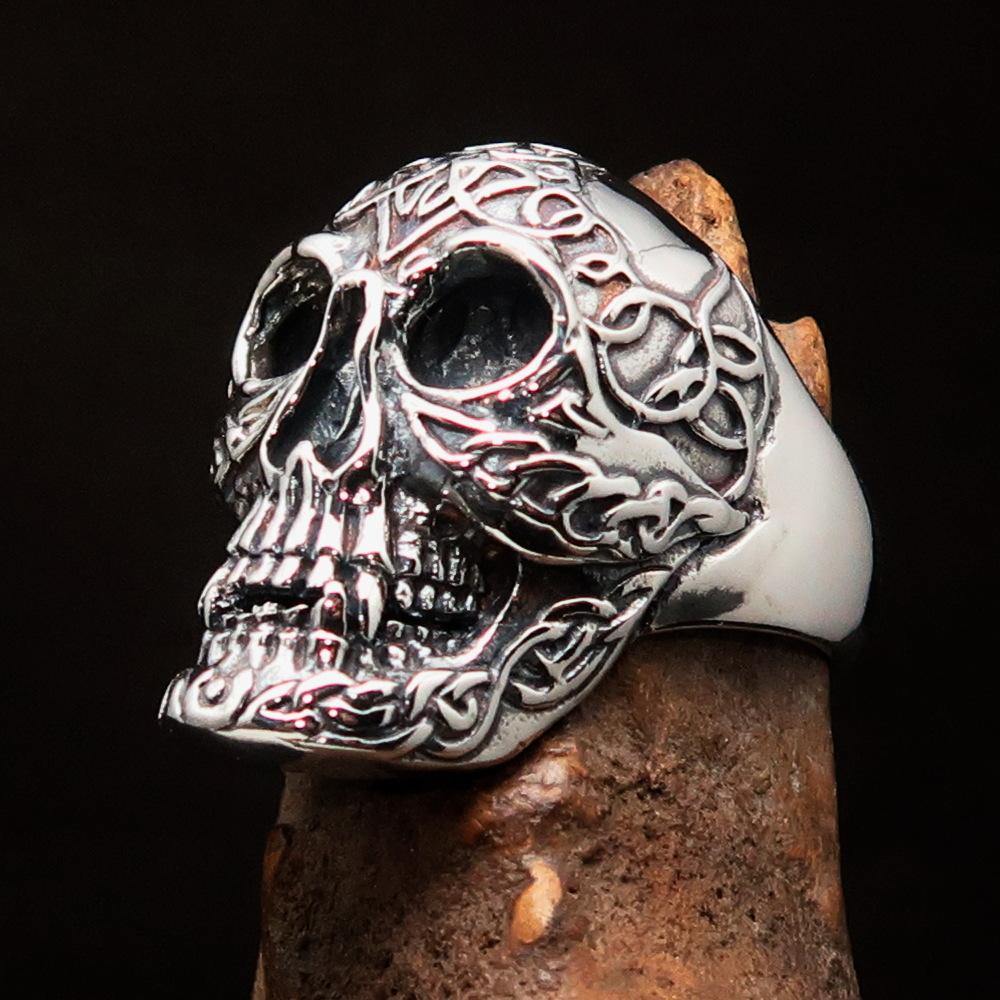 Men's sterling silver Celtic skull ring with intricate design and polished finish, showcasing its unique craftsmanship.