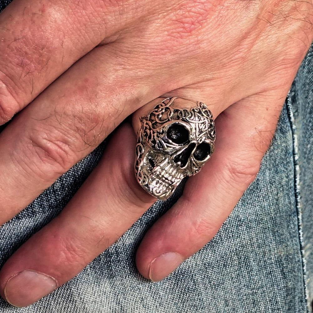 Men's sterling silver Celtic skull ring with intricate design and polished finish, showcasing its unique craftsmanship.