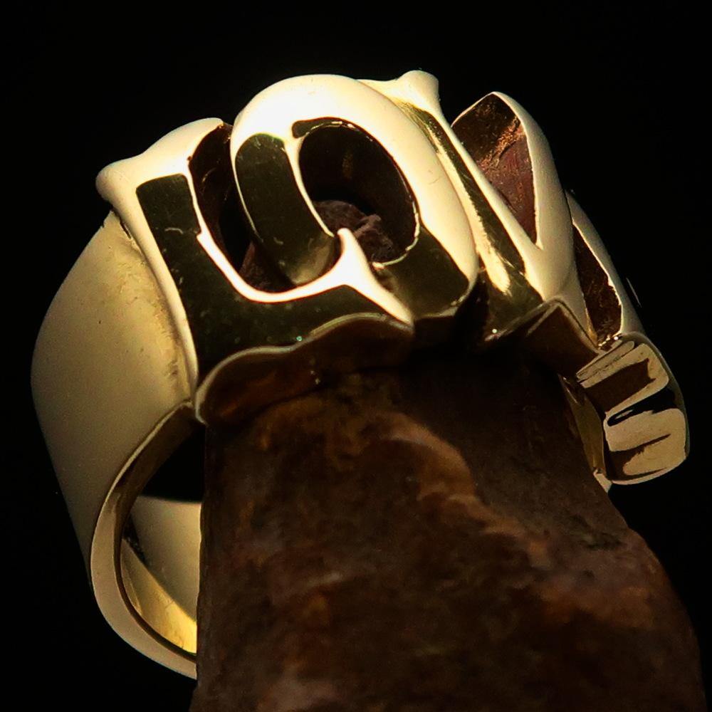 A high-polished solid brass One Word Love Ring, showcasing its elegant design and 12 mm width.
