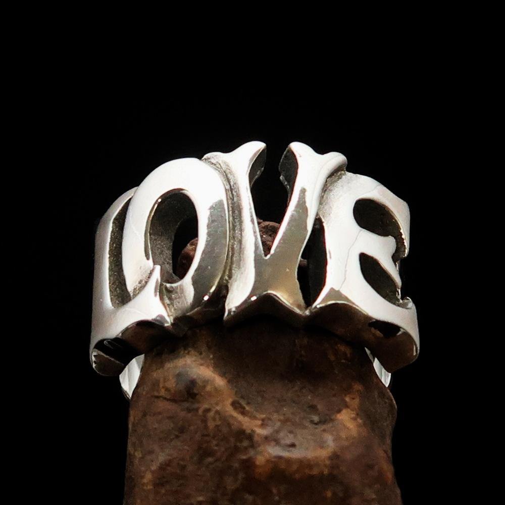 A beautifully crafted sterling silver One Word Love Ring, hallmarked 925, showcasing its high-polished finish and elegant design.