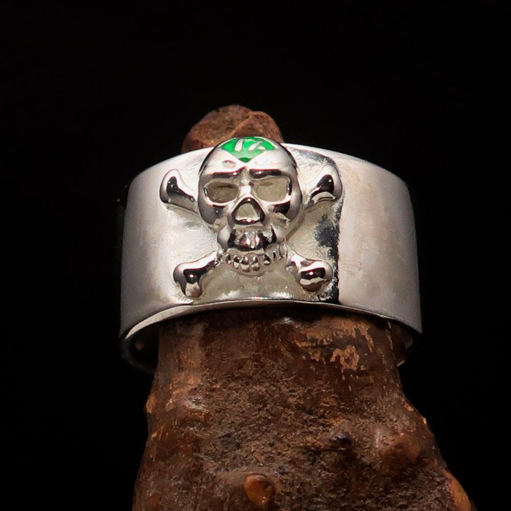 Outlaw green 1% Jolly Roger Skull Band Ring made of solid sterling silver with green enamel detailing, showcasing a polished finish.
