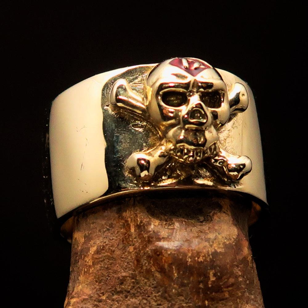 Outlaw red 1% Jolly Roger Skull Band Ring made of solid brass with a polished finish and red enamel detailing.