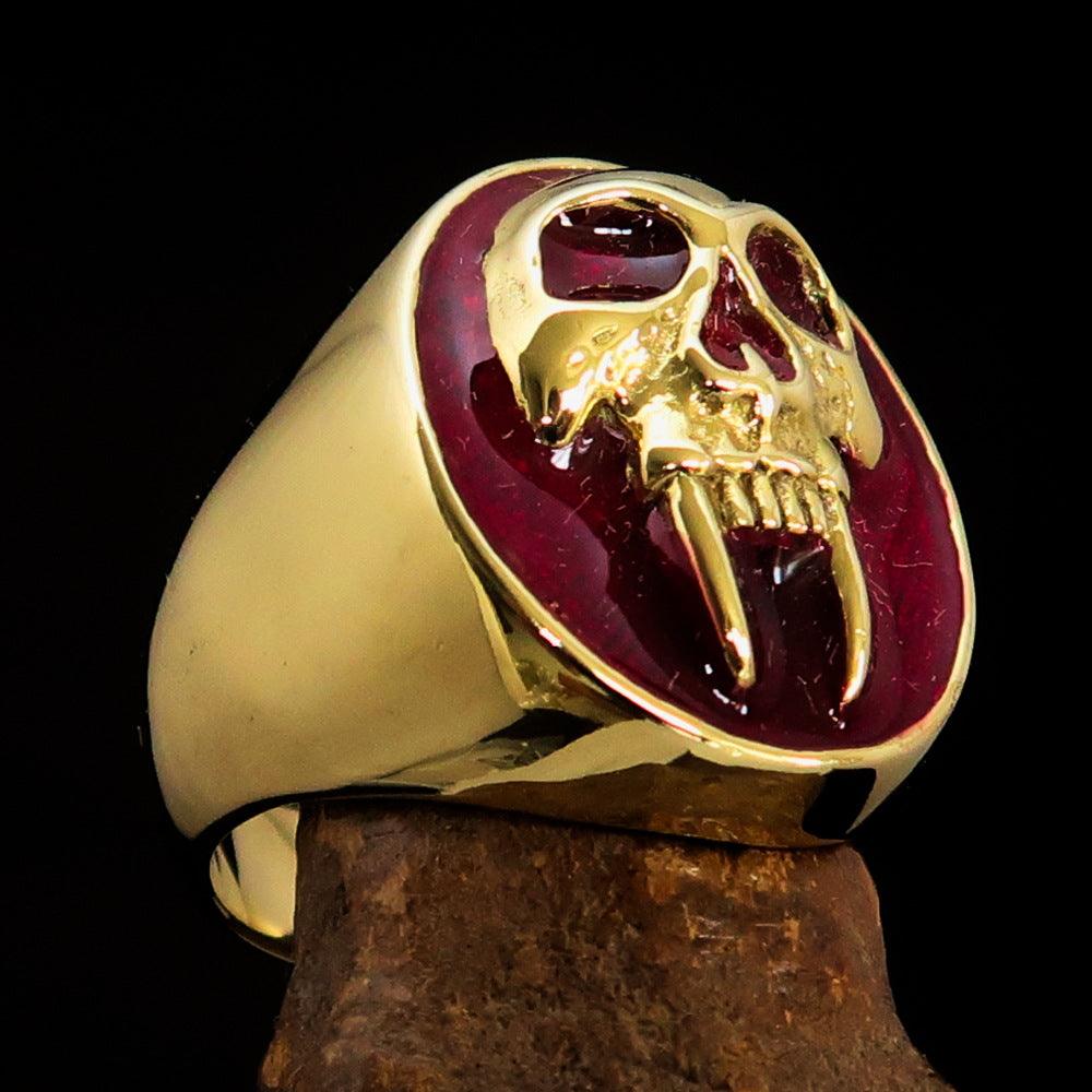 Men's red vampire skull ring made of solid brass with high polish and red enamel finish, showcasing an oval design.