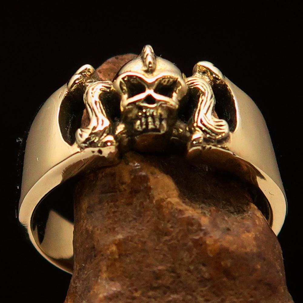 Antiqued brass Pony Tail Girly Skull Ring showcasing unique design and polished finish.