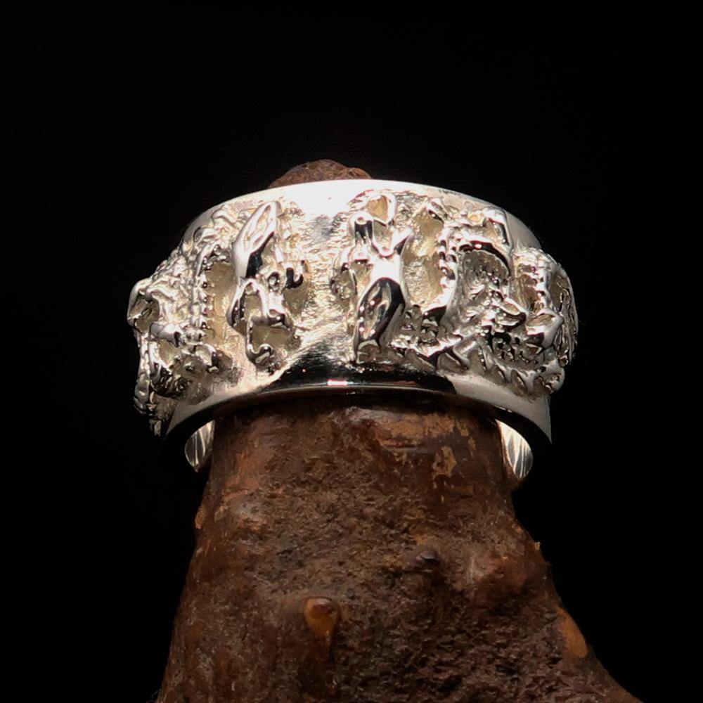 Men's sterling silver ring featuring two intricately designed dragons with a shiny mirror polish.