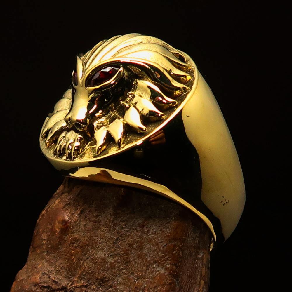 Solid brass men's predator ring featuring a lion design with red cubic zirconia eyes, showcasing intricate craftsmanship and a high polish finish.