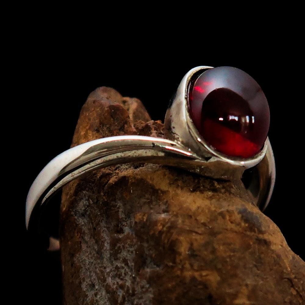 A beautifully crafted Women's Ring featuring a red Garnet Cabochon set in high polished Sterling Silver, showcasing its elegant design.