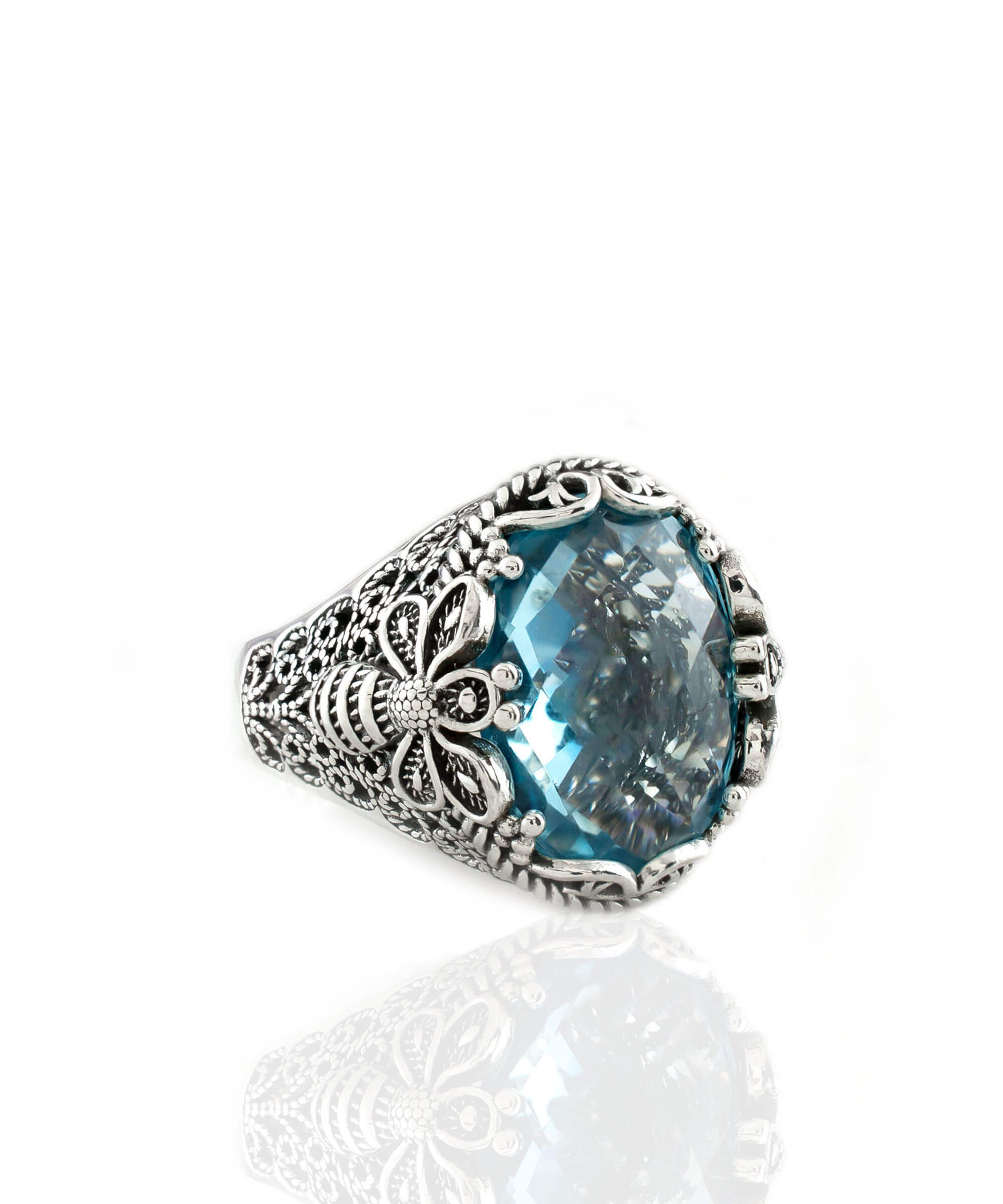 A stunning 925 sterling silver ring featuring a blue topaz gemstone with a filigree art bee design, elegantly presented in a luxurious gift box.