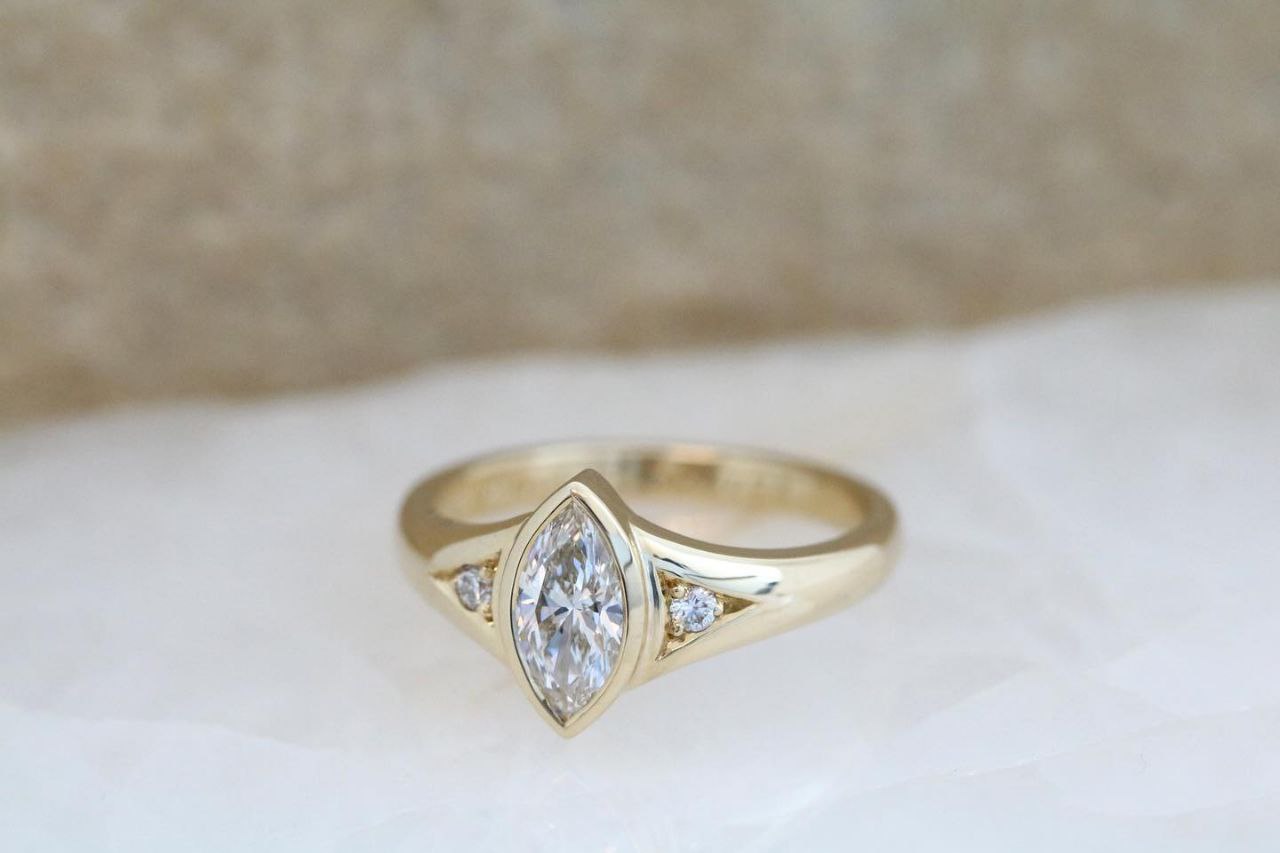 Gold plated silver ring featuring a marquise cut natural white zircon stone, showcasing elegance and sophistication.