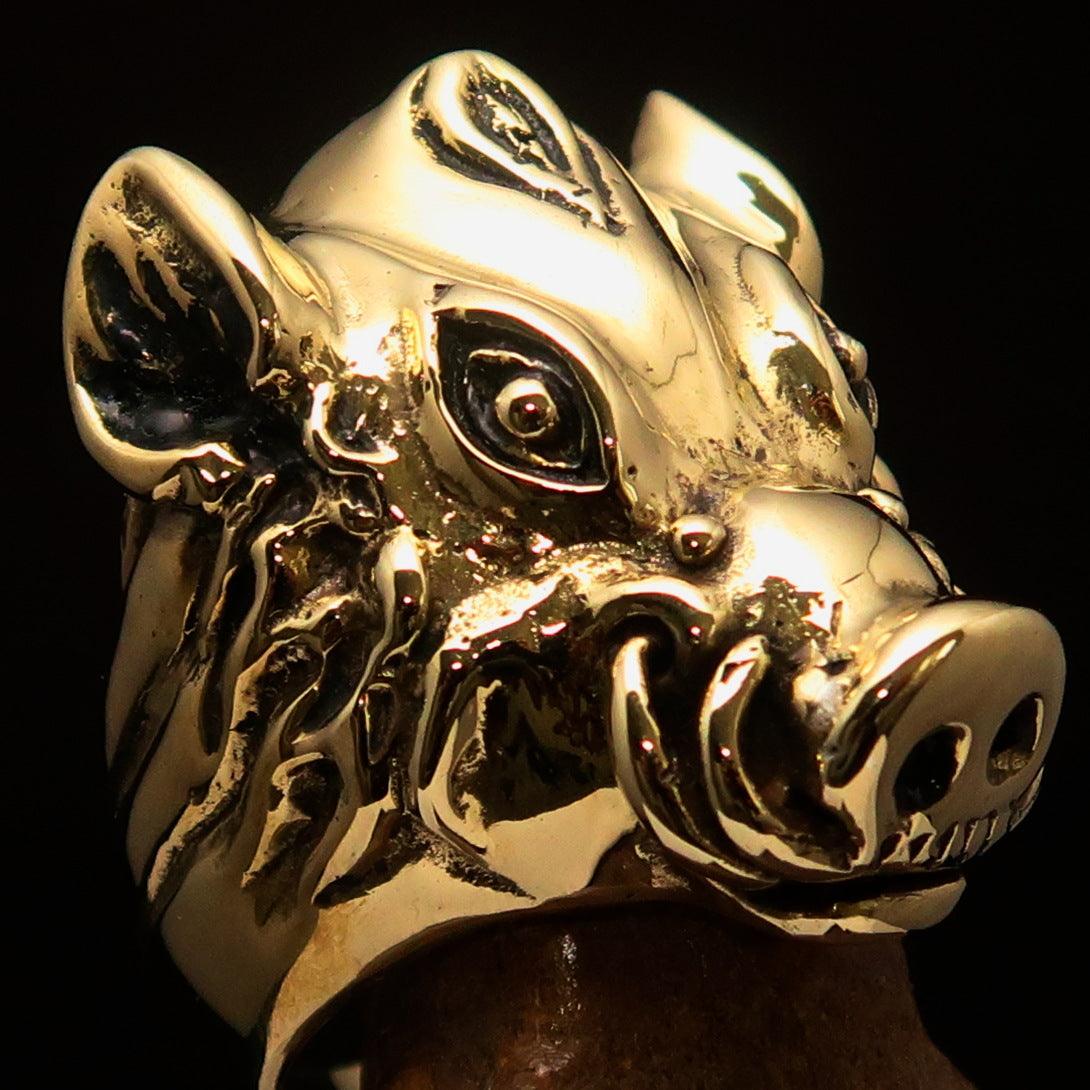 Heavy crafted biker ring featuring a detailed boar design in antiqued brass, showcasing vintage charm and bold aesthetics.