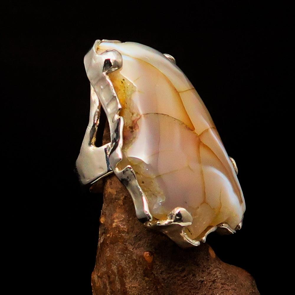 Huge sterling silver solitaire ring featuring a fancy cut agate slice, showcasing its unique patterns and polished finish.