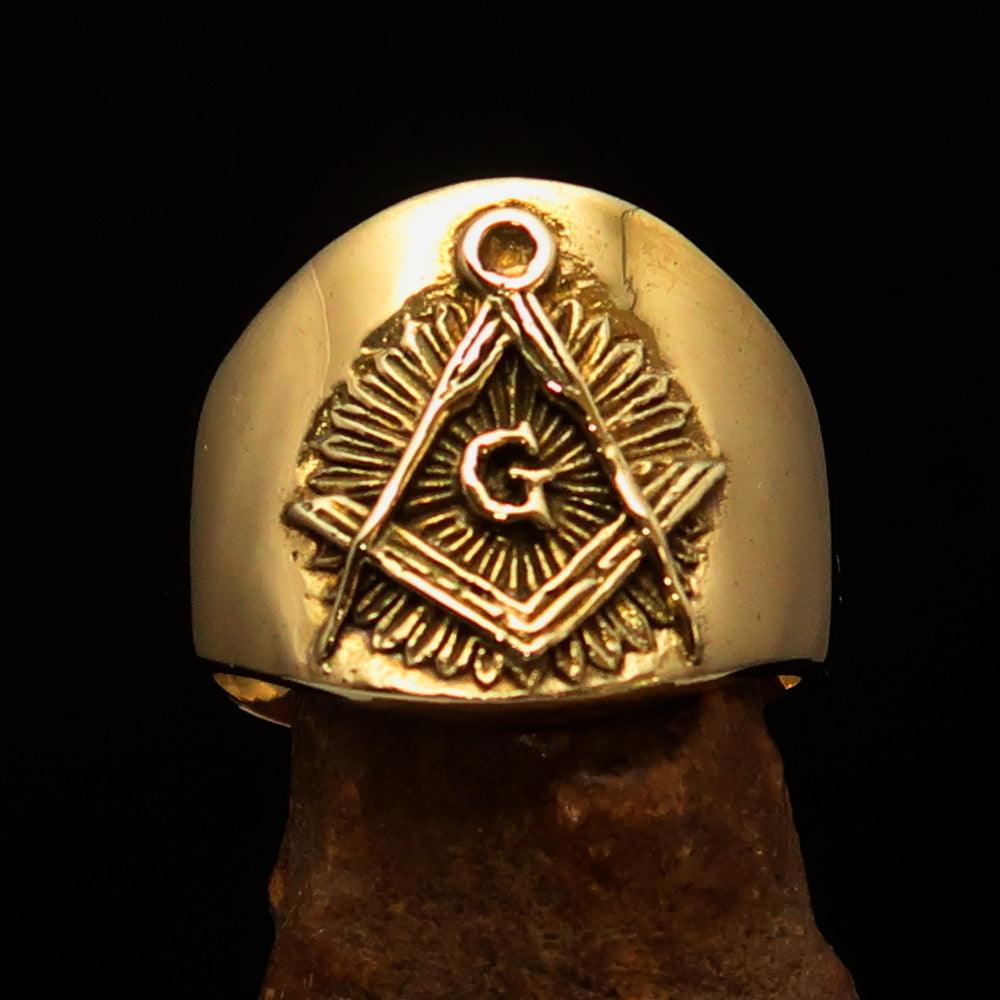 Men's shiny brass Masonic pinky ring featuring square and compasses symbol, polished finish, and available in multiple sizes.