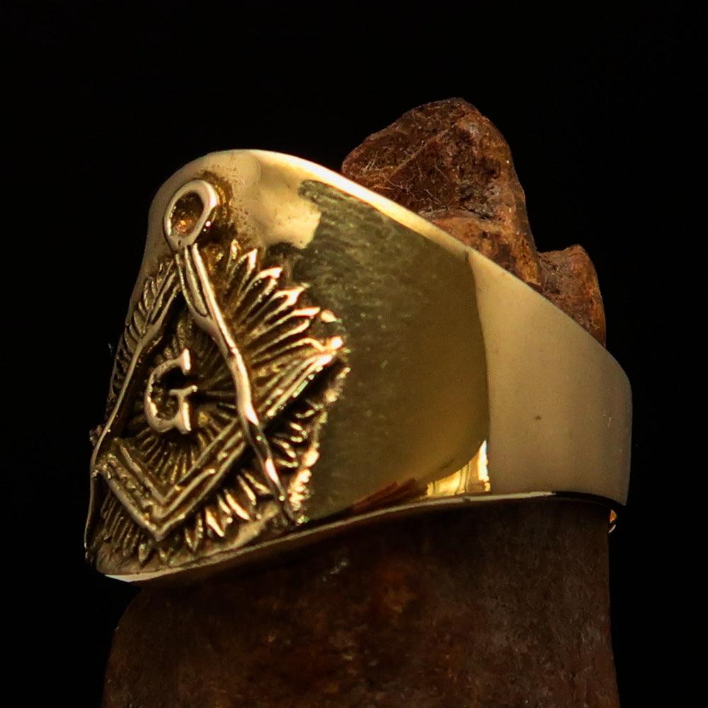 Men's shiny brass Masonic pinky ring featuring square and compasses symbol, polished finish, and available in multiple sizes.