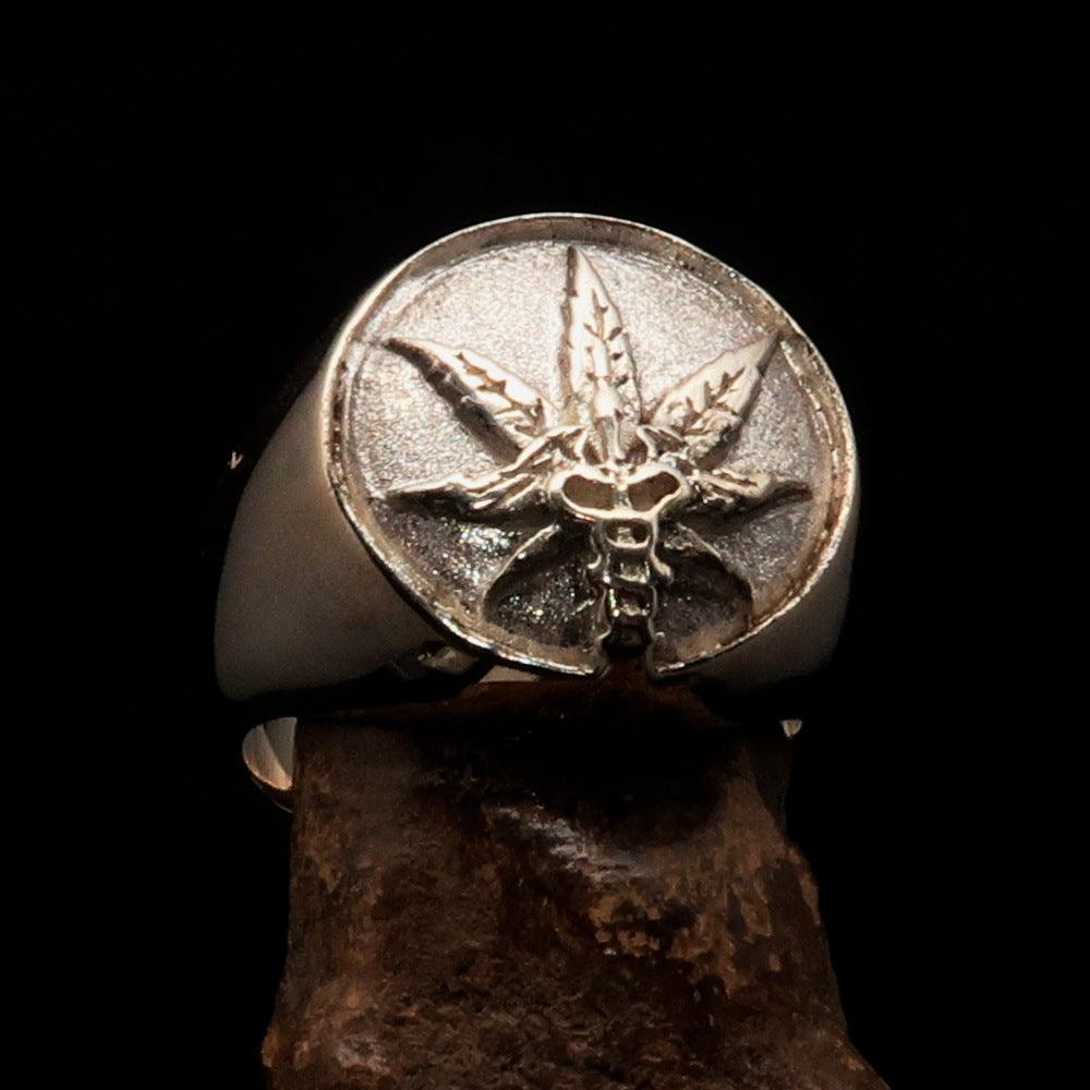 Men's sterling silver ring featuring a cannabis leaf symbol with a two-tone finish, showcasing high polish and matte textures.