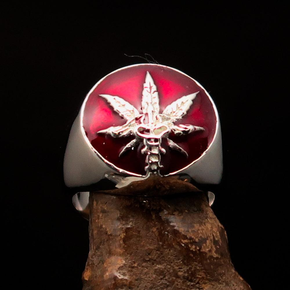 Men's sterling silver ring featuring a cannabis leaf symbol with red enamel, hallmarked 925, showcasing intricate design.