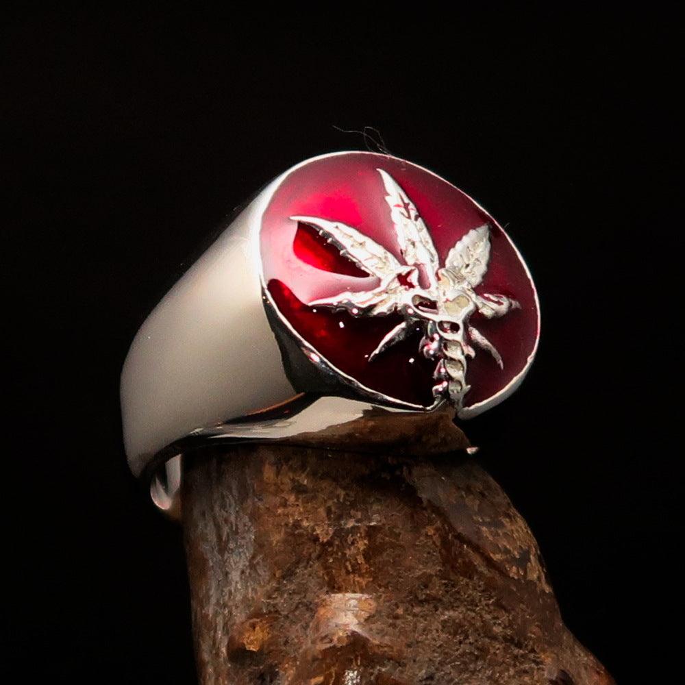 Men's sterling silver ring featuring a cannabis leaf symbol with red enamel, hallmarked 925, showcasing intricate design.