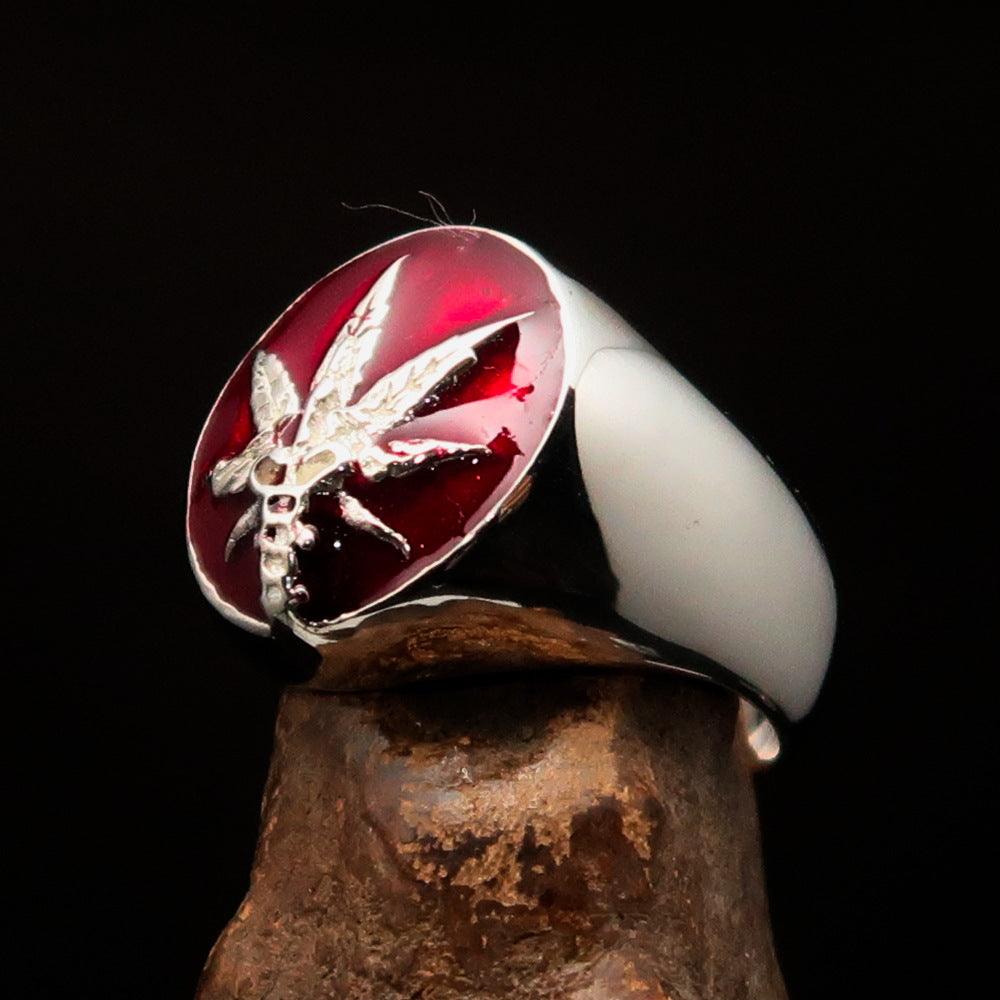 Men's sterling silver ring featuring a cannabis leaf symbol with red enamel, hallmarked 925, showcasing intricate design.