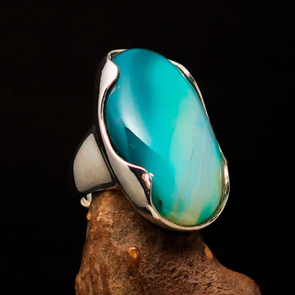 Minimalistic sterling silver ring featuring an oval-shaped green Agate cabochon, polished to a mirror finish.