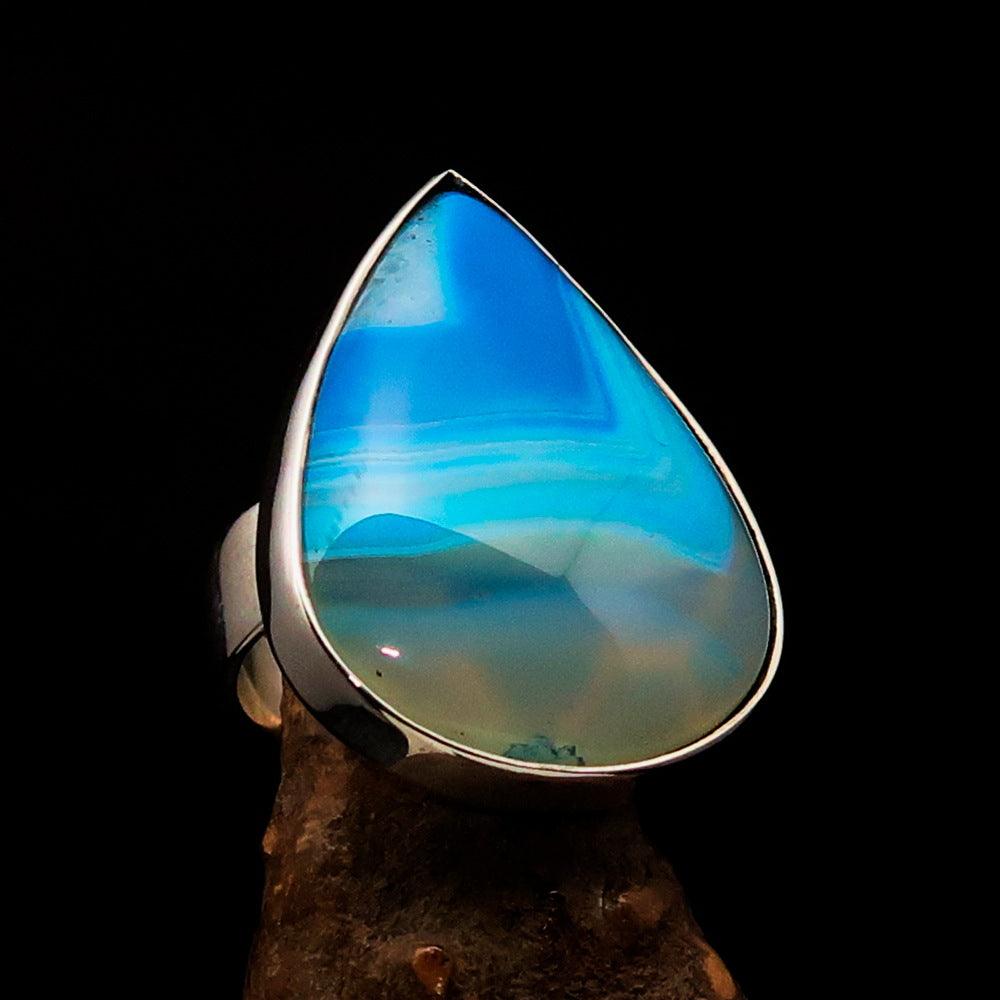 Minimalistic sterling silver ring featuring a pear-shaped blue agate cabochon, polished to a mirror finish.