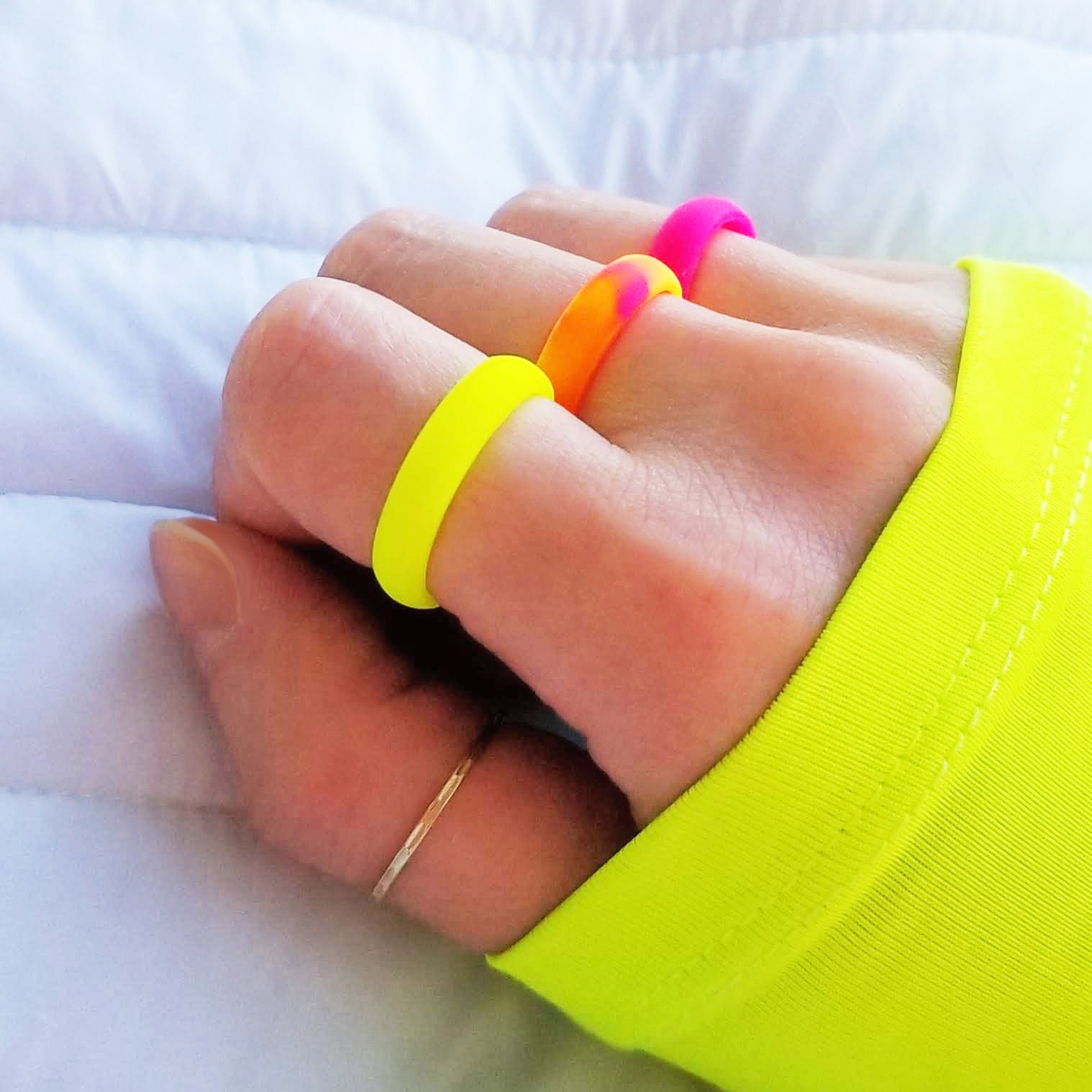 Neon hot pink breathable silicone ring with a sleek bevel design, showcasing its smooth surface and ergonomic fit.