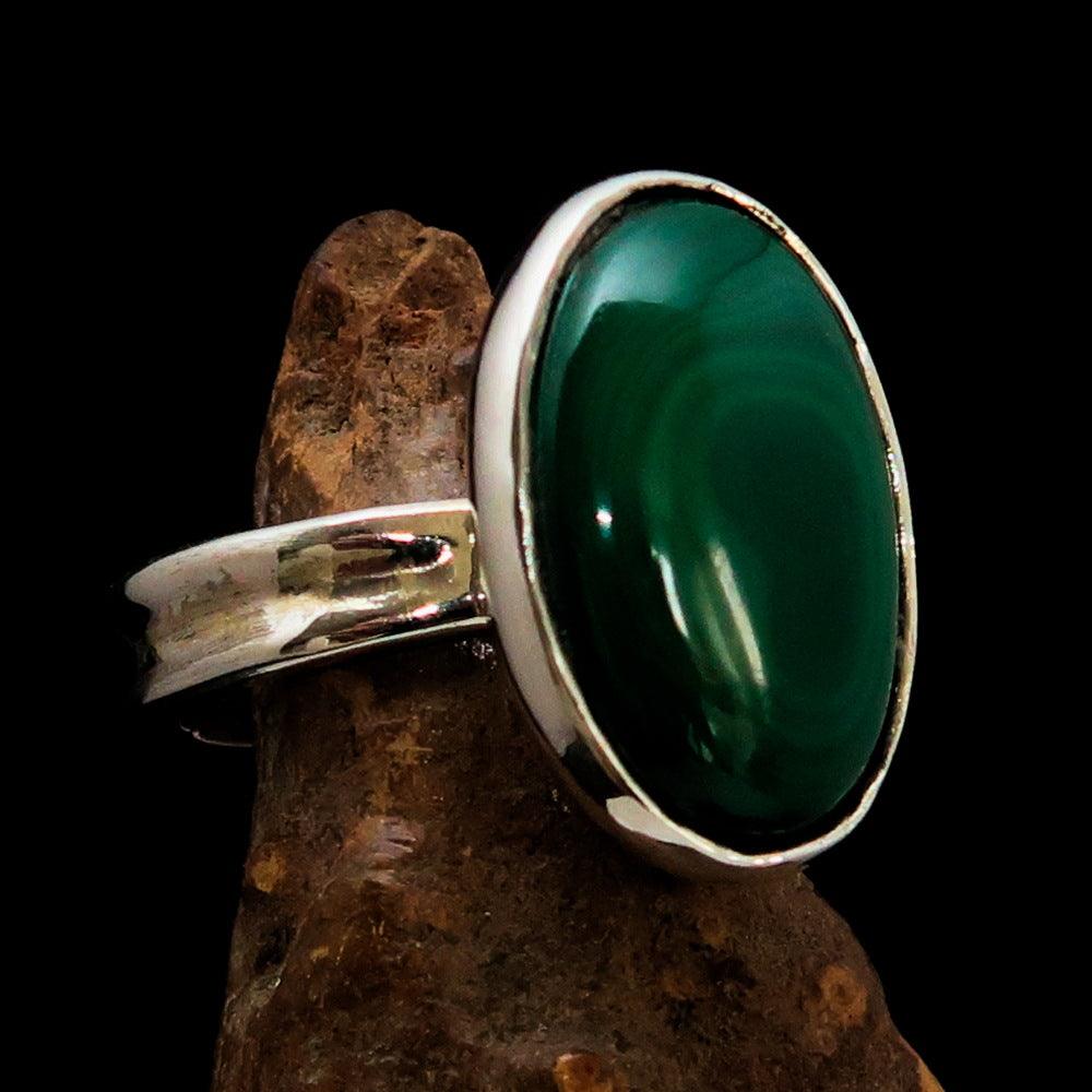Oval shaped mirror polished sterling silver ring featuring a vibrant green malachite stone, hallmarked 925.