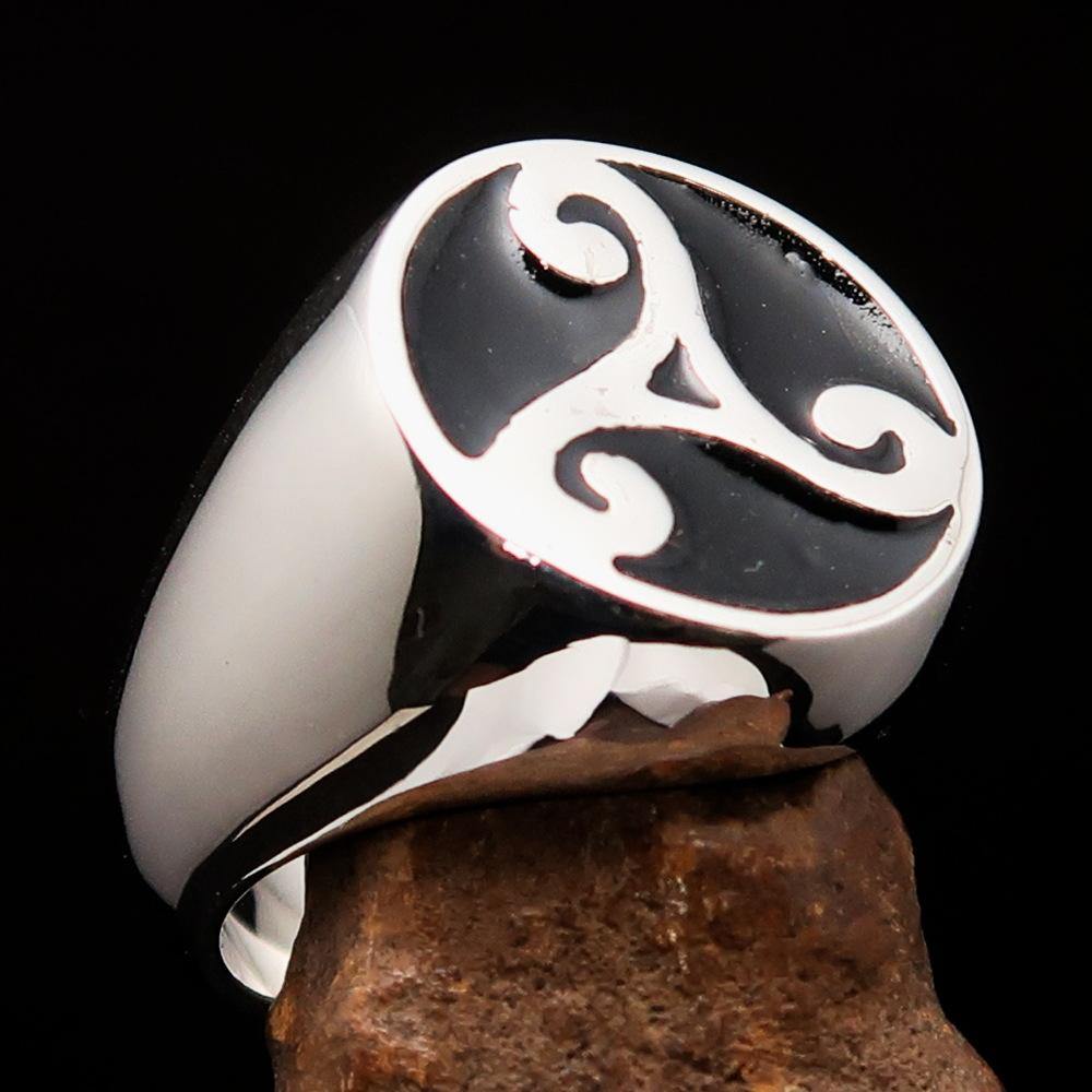 Men's Celtic Triade Ring made of sterling silver with a black enamel triskele design, showcasing its polished finish and intricate details.