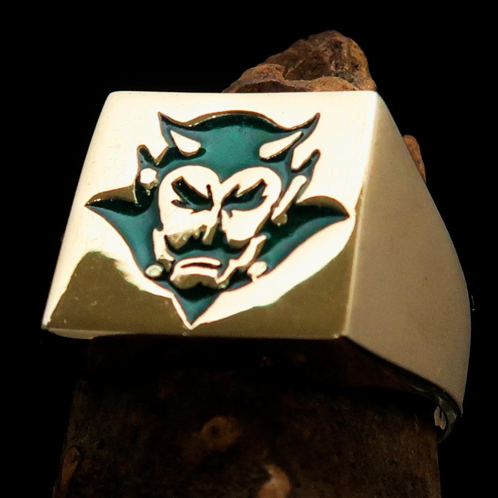 Men's Devil Ring made of solid brass with high polish and vibrant green enamel, showcasing its unique design and craftsmanship.