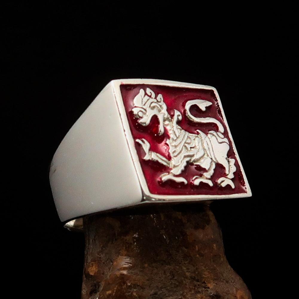 Men's red Sinhalese lion ring made of sterling silver with intricate detailing and vibrant red enamel accents.