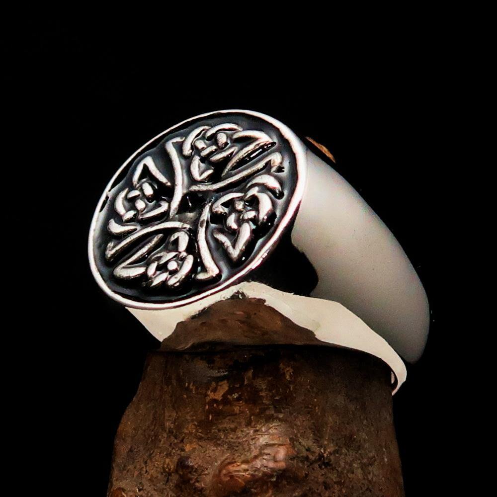 Men's sterling silver ring featuring Celtic Birgit's Cross design with black enamel finish, showcasing high polish and intricate details.
