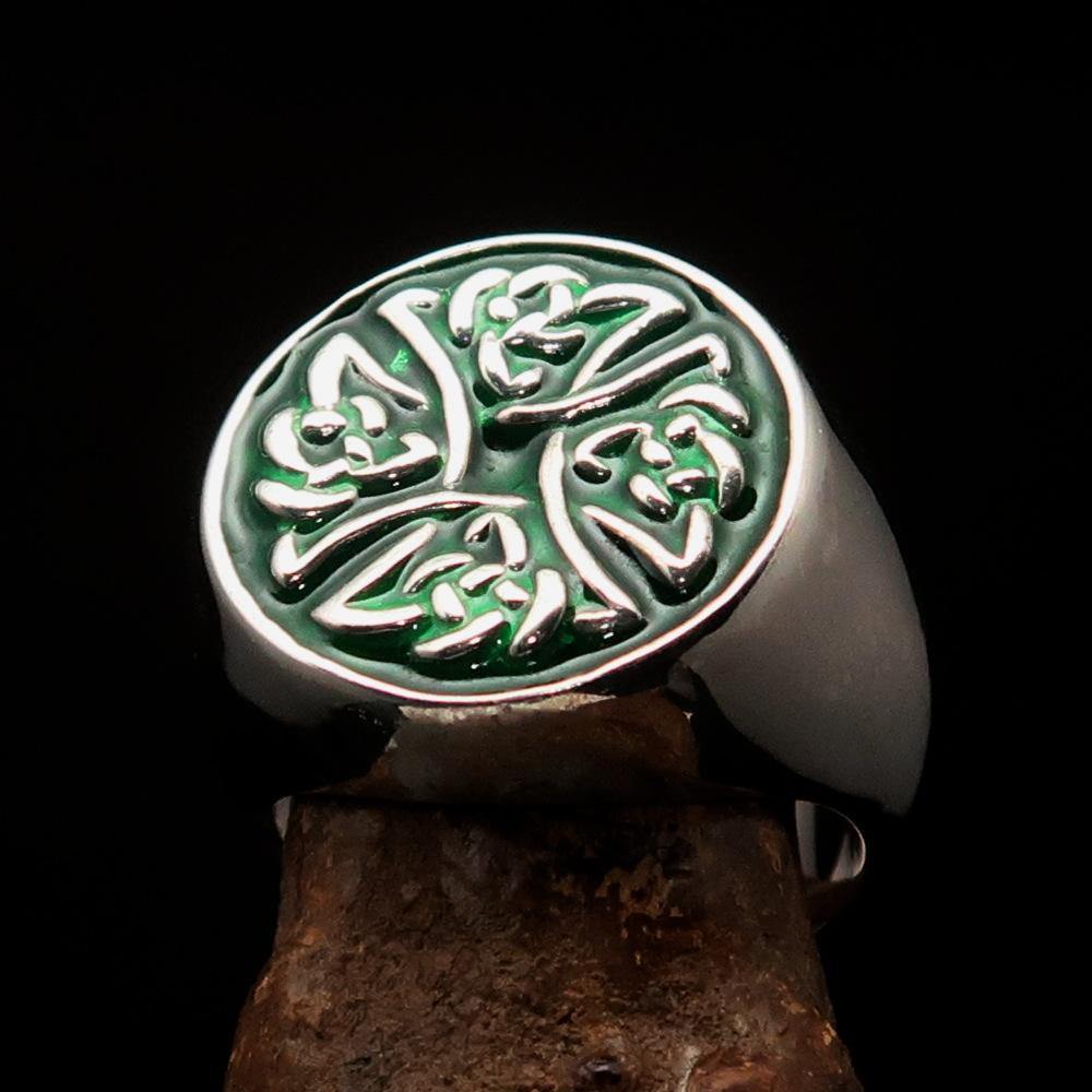 Men's sterling silver ring featuring Celtic Birgit's Cross design with vibrant green enamel, showcasing intricate craftsmanship.