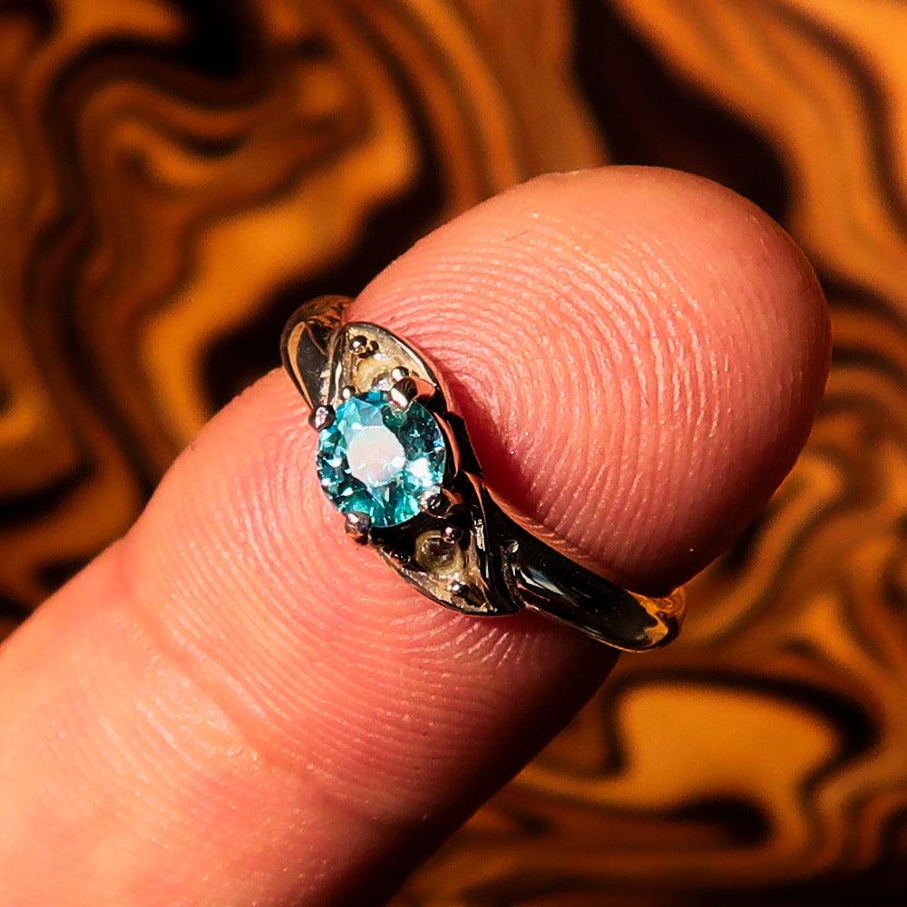 Sterling Silver Gemstone Solitaire Ring featuring an oval cut Blue Zircon and two white CZ stones, hallmarked 925.