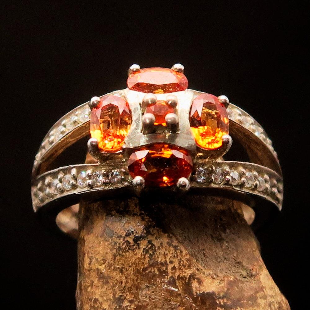 Sterling Silver Ring featuring an oval cut orange sapphire and 28 white cubic zirconia stones, size 6.5.