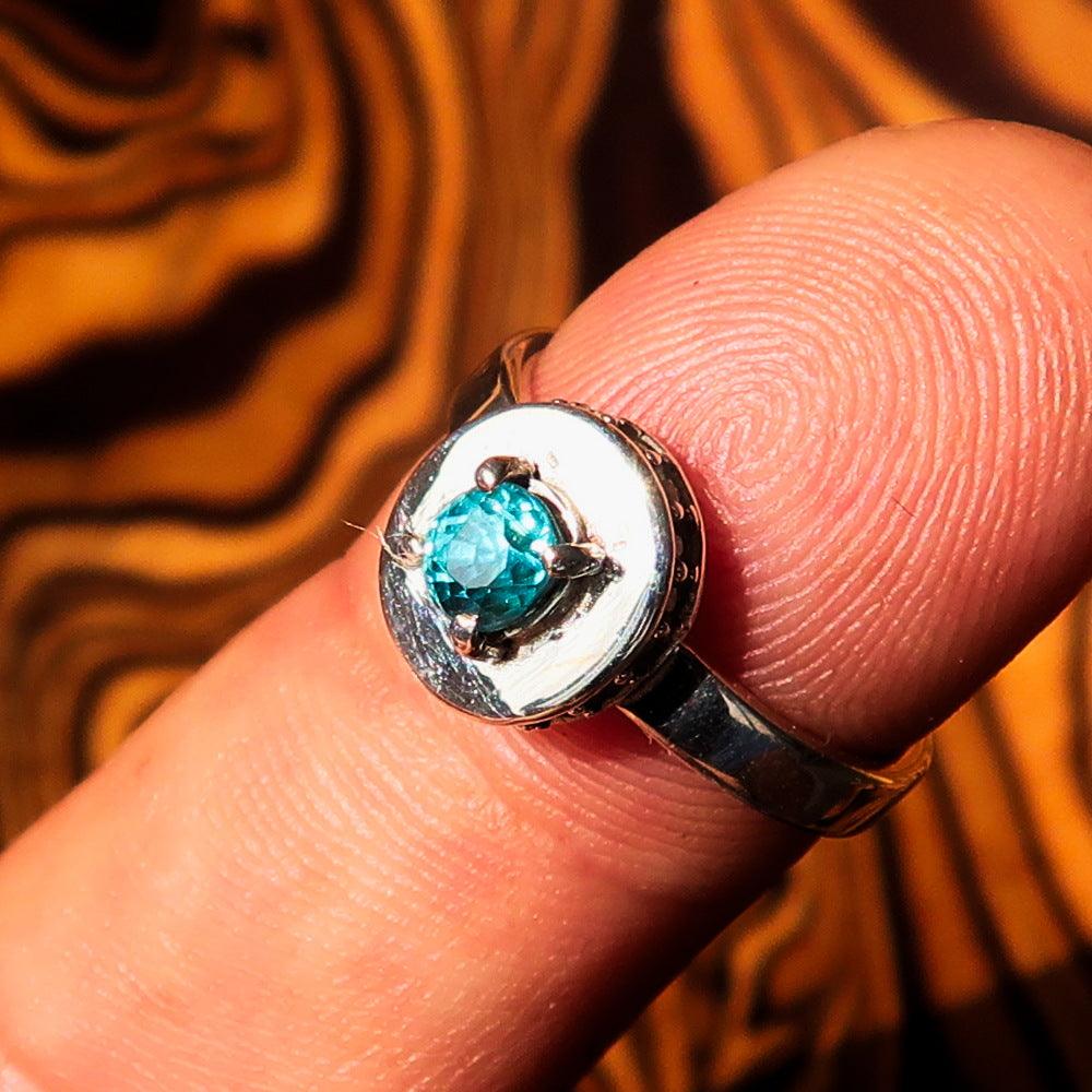 Sterling Silver Solitaire Ring featuring an oval cut Blue Zircon and 15 white CZ stones, showcasing its elegant design and polished finish.