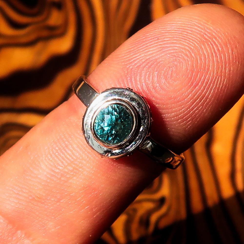 Sterling Silver Solitaire Ring featuring an oval cut Blue Zircon and 15 white CZ stones, hallmarked 925, elegant design.