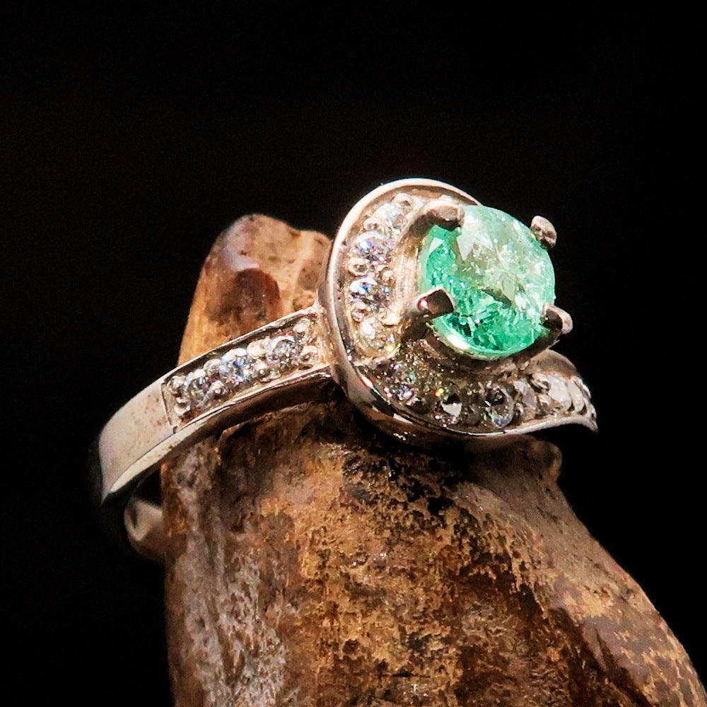 Sterling Silver Solitaire Ring featuring an oval cut Green Emerald and 18 round white Cubic Zirconias, hallmarked 925.