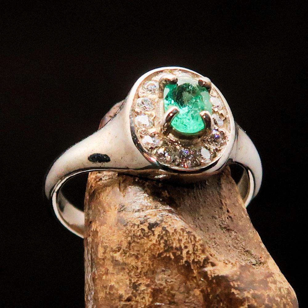 Sterling Silver Solitaire Ring featuring an oval Green Emerald and 14 white Cubic Zirconia stones, elegantly designed and polished.