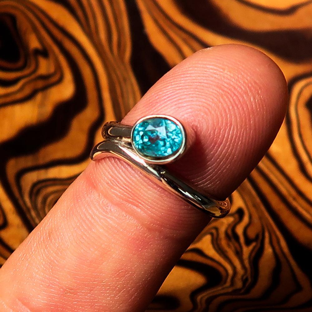 Sterling Silver Women's Band Ring featuring an oval cut blue Zircon, size 6.5, polished finish.