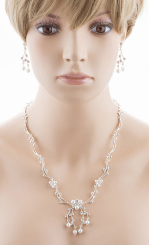 Bridal Wedding Jewelry Set featuring a Crystal Rhinestone Floral Pearl Necklace and matching earrings, elegantly displayed on a soft fabric background.