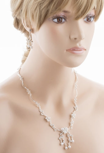 Bridal Wedding Jewelry Set featuring a Crystal Rhinestone Floral Pearl Necklace and matching earrings, elegantly displayed on a soft fabric background.